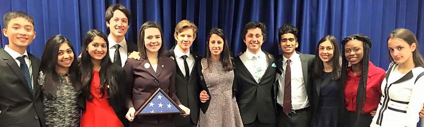 Group of USA debate alumni standing together.